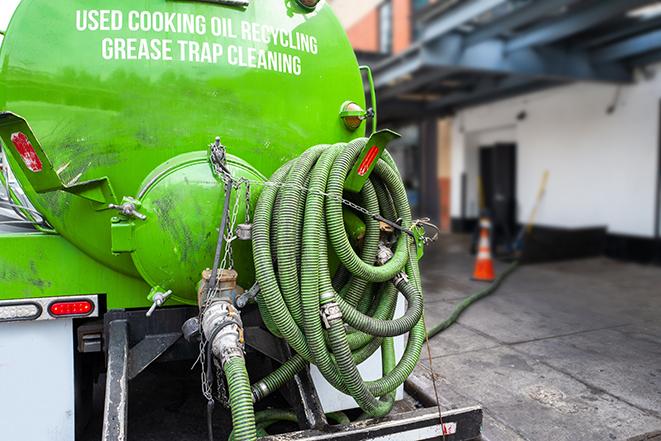 a grease trap being pumped by a sanitation technician in Lake Stevens